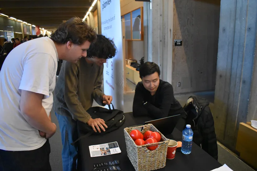 Students looking at laptop at Planview booth